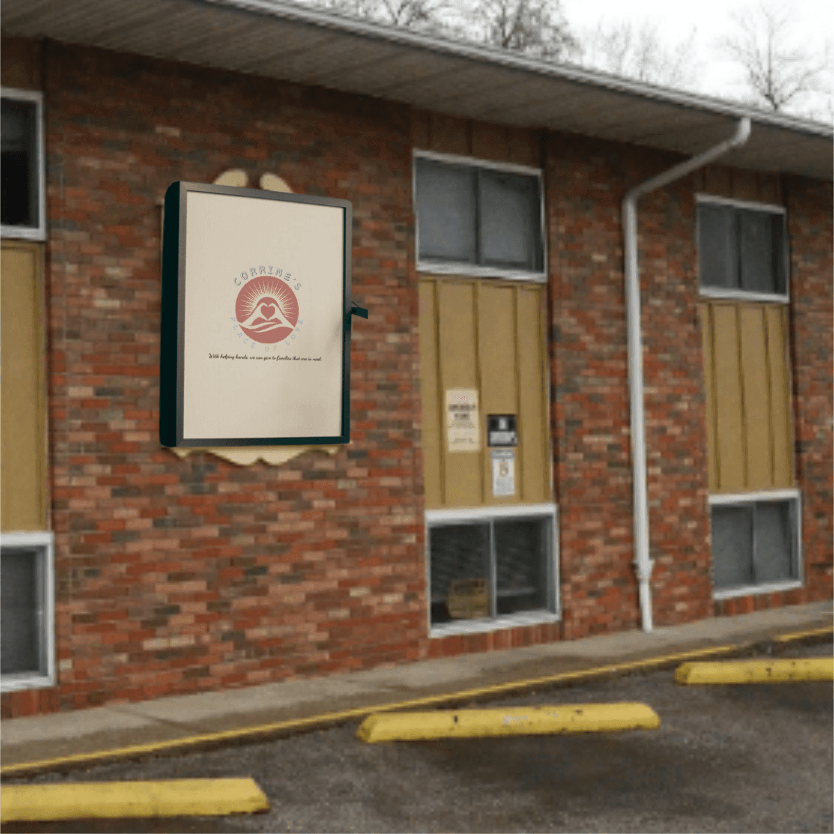 Brick building exterior with a sign displaying a logo and text.