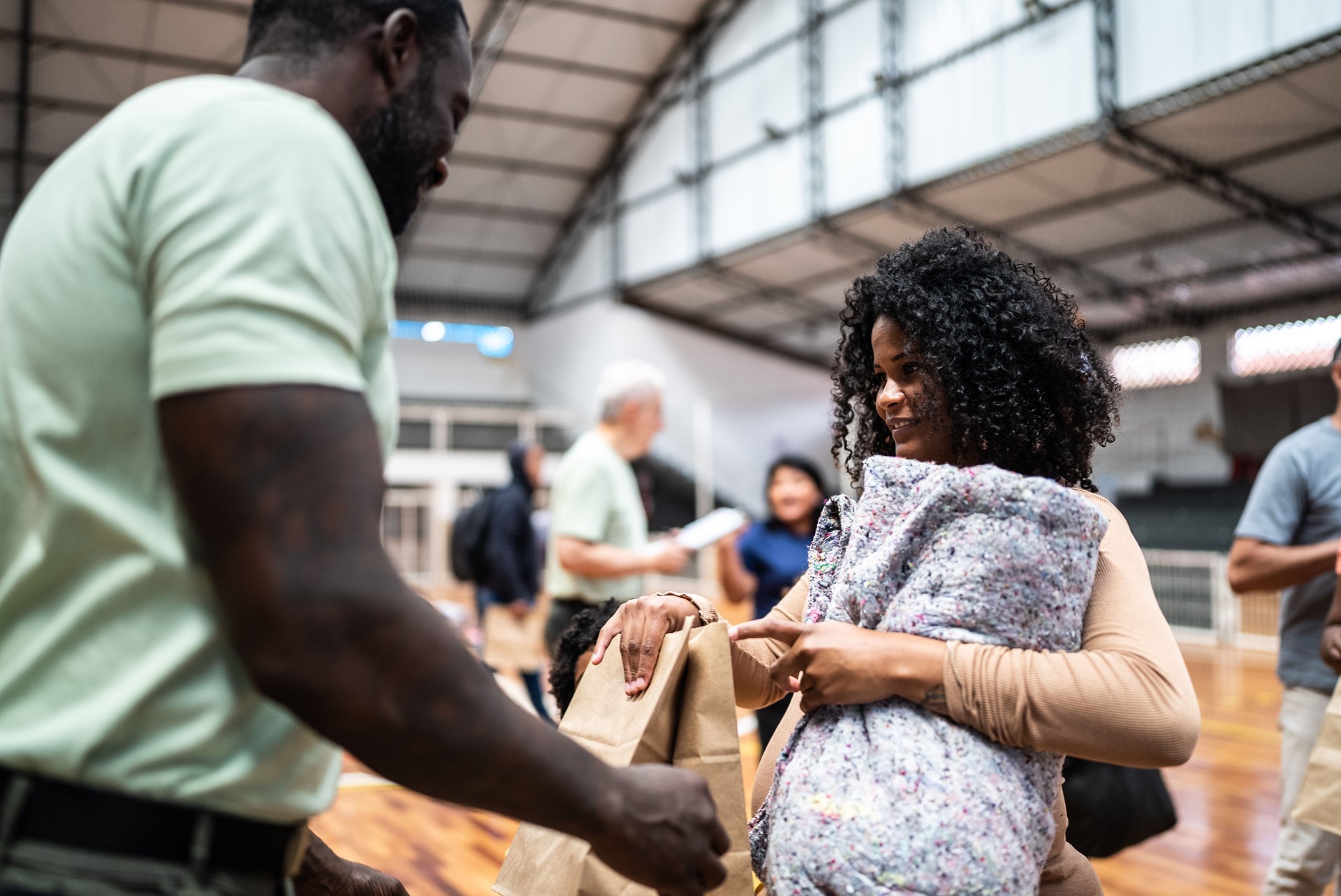 Refugee family getting a donation in a sheltering